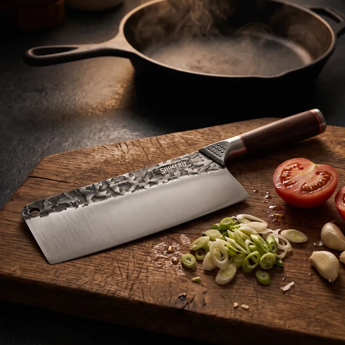 Saba 7" Stainless Steel Cleaver on an oak board with spring onions, tomato and garlic