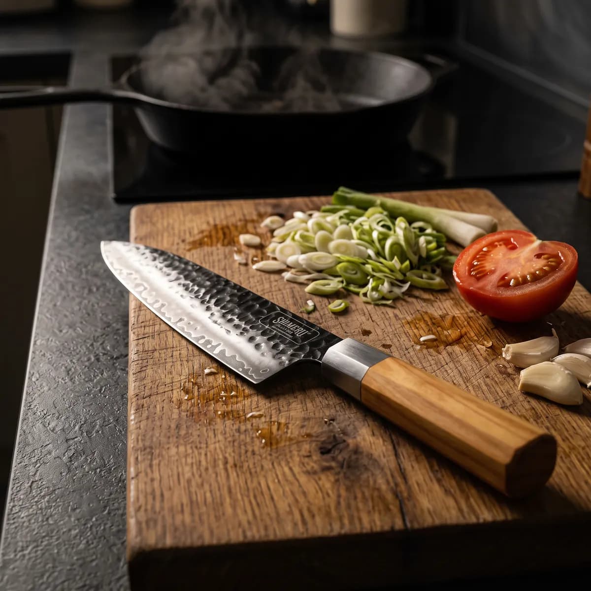 Kakehashi 8" Gyuto on an oak board with spring onions, tomato and garlic