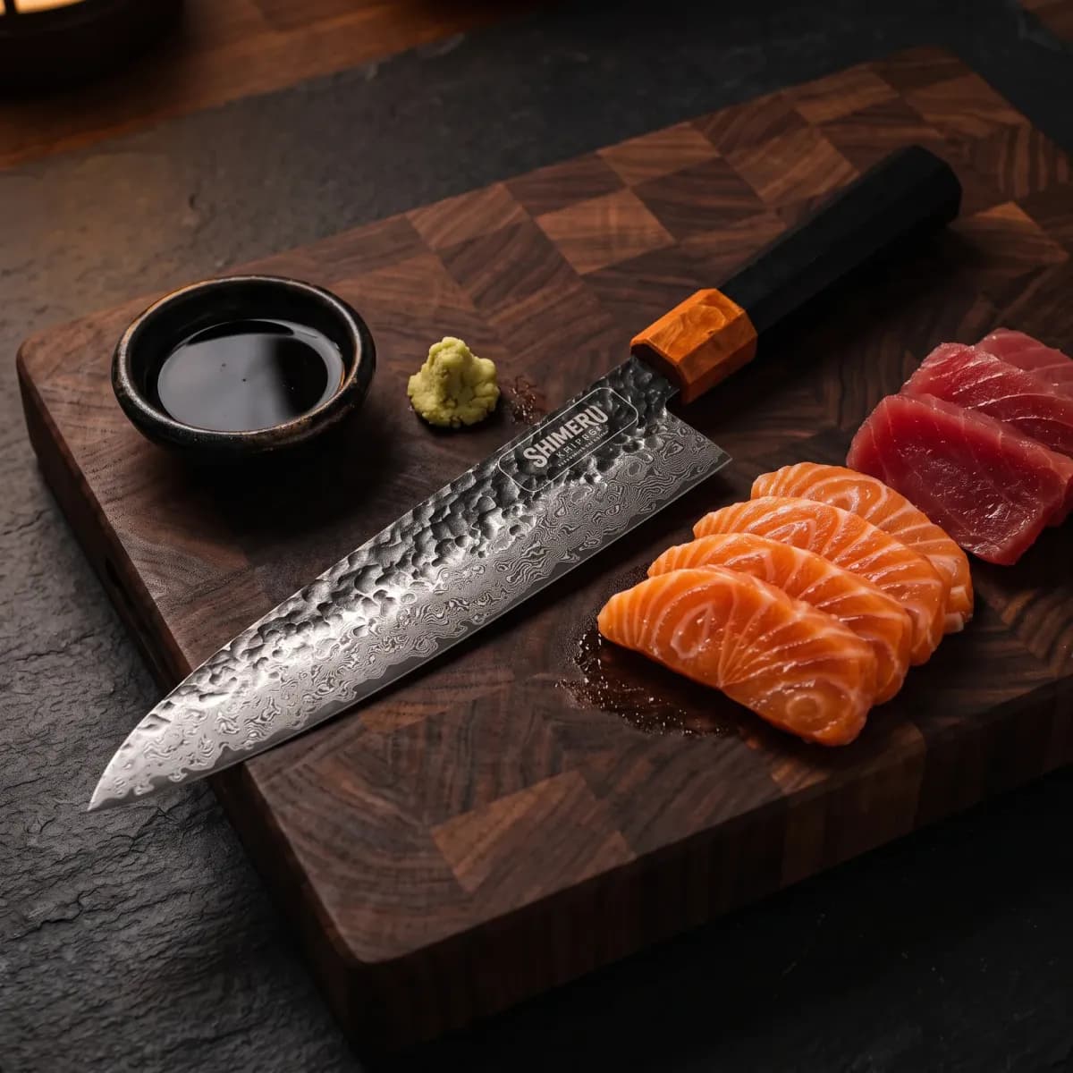 Kumozu 8'' Damascus Steel Gyuto Knife beside sliced salmon and tuna sashimi