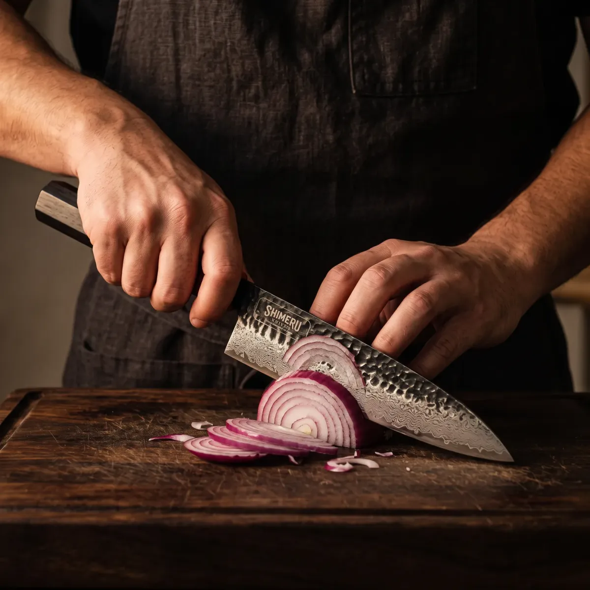 Kumozu 8'' Damascus Steel Gyuto Knife slicing a red onion paper thin