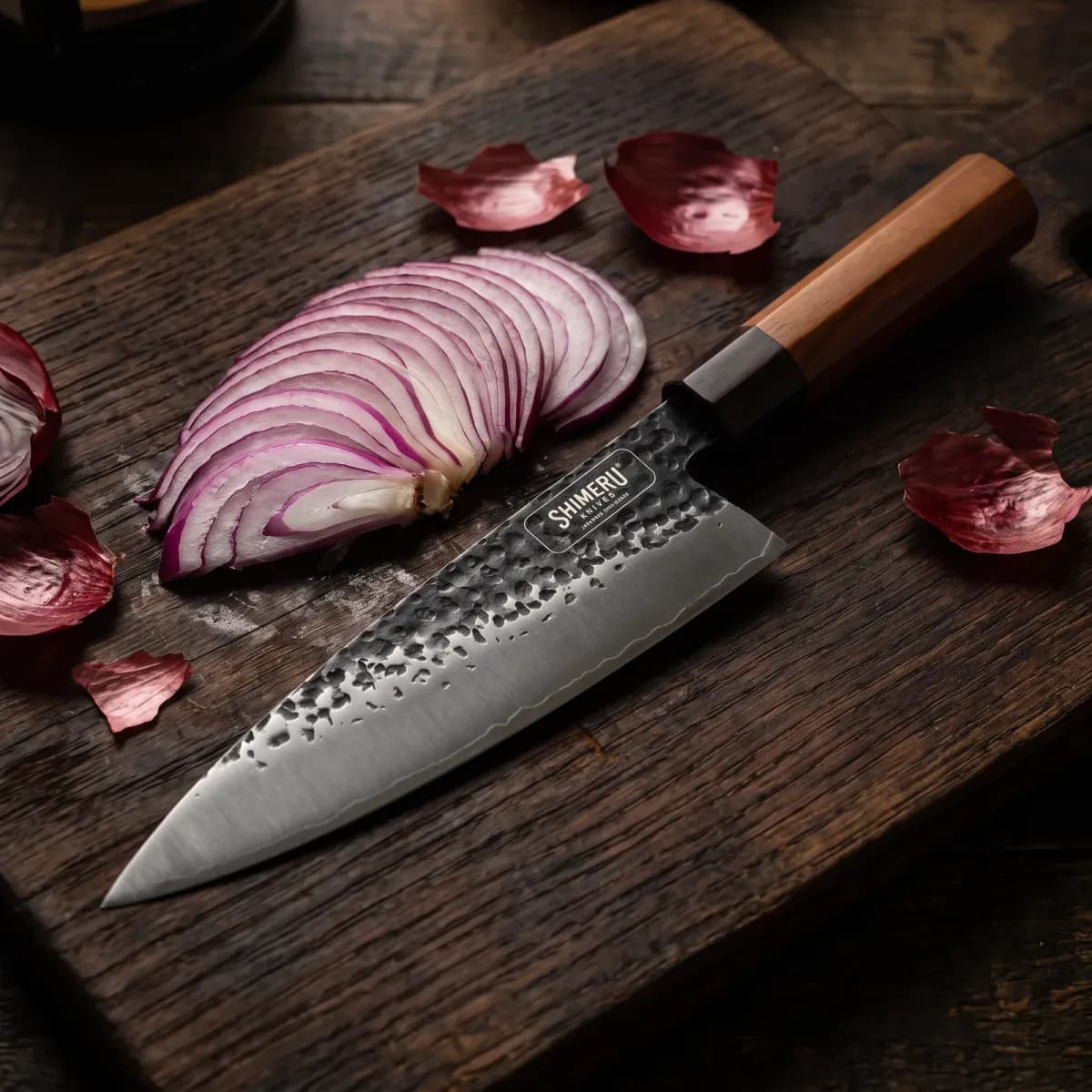 Tokachi 8.5" Gyuto Chef Knife beside a thinly sliced red onion