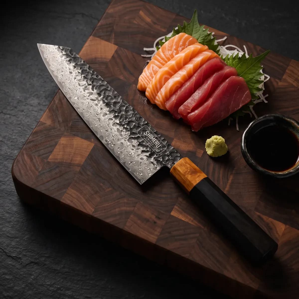 Kurobe 9.5" Damascus Steel Kiritsuke Knife beside sliced salmon and tuna sashimi