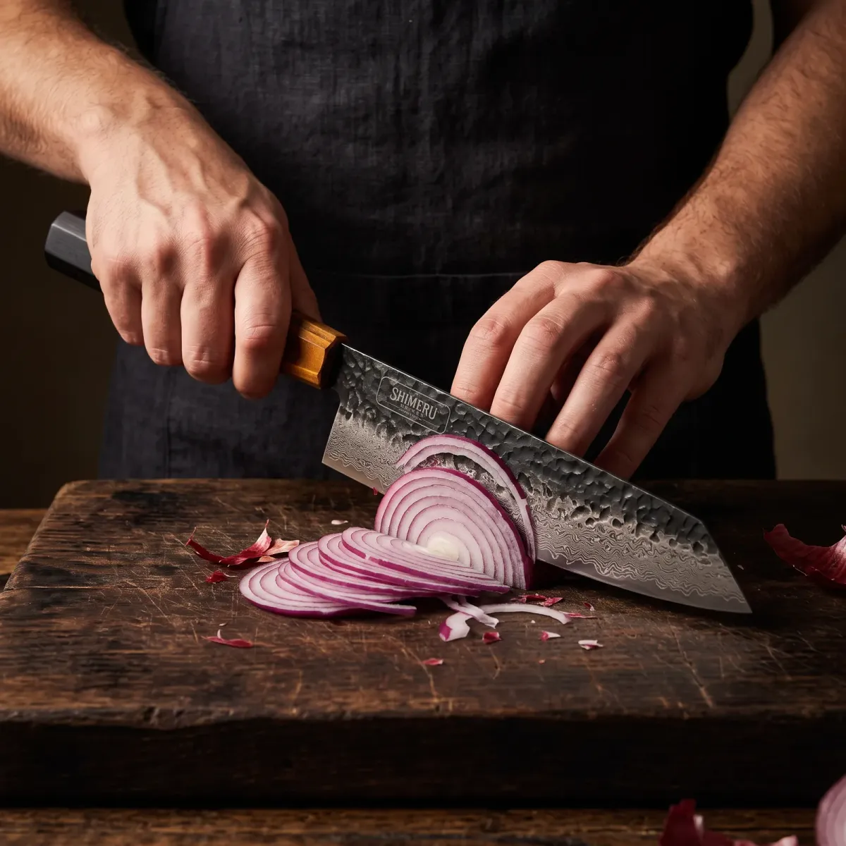 Kurobe 9.5" Damascus Steel Kiritsuke Knife slicing a red onion paper thin
