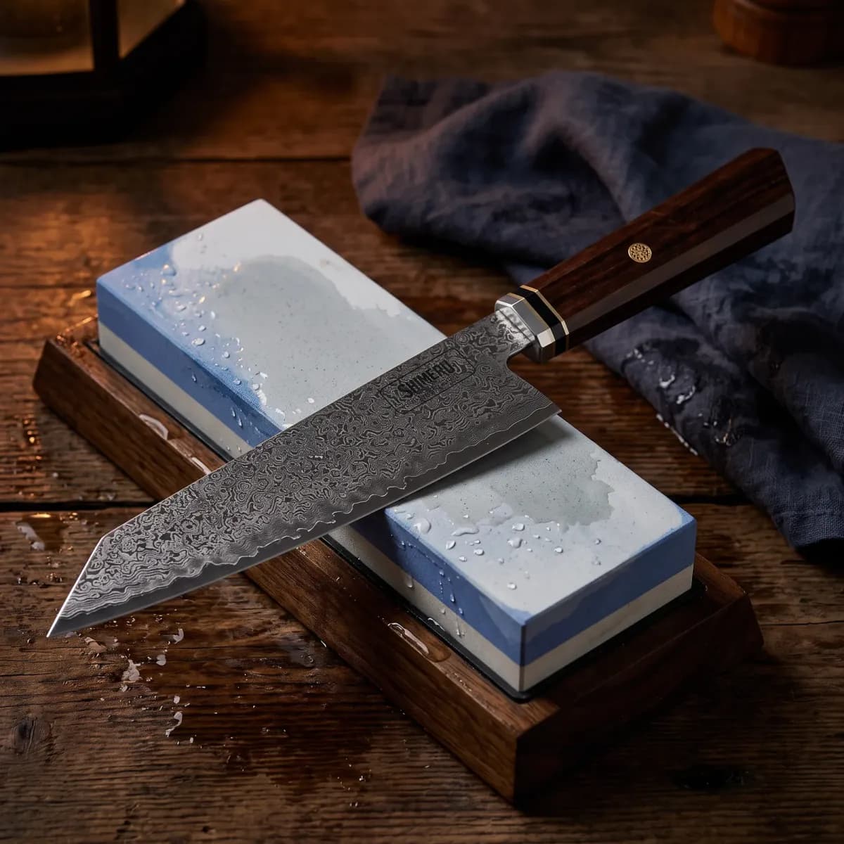 Tenryu 8" Damascus Steel Kiritsuke Knife being sharpened on a wet whetstone