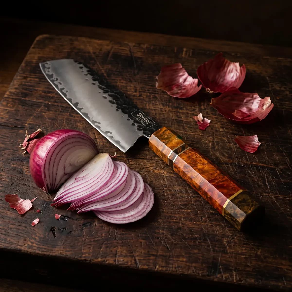 Ishikari 5" Santoku Knife beside a thinly sliced red onion