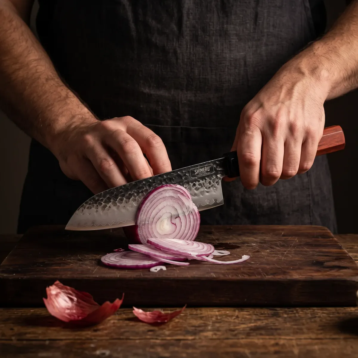 Yodo 7.5" Santoku Knife slicing a red onion paper thin