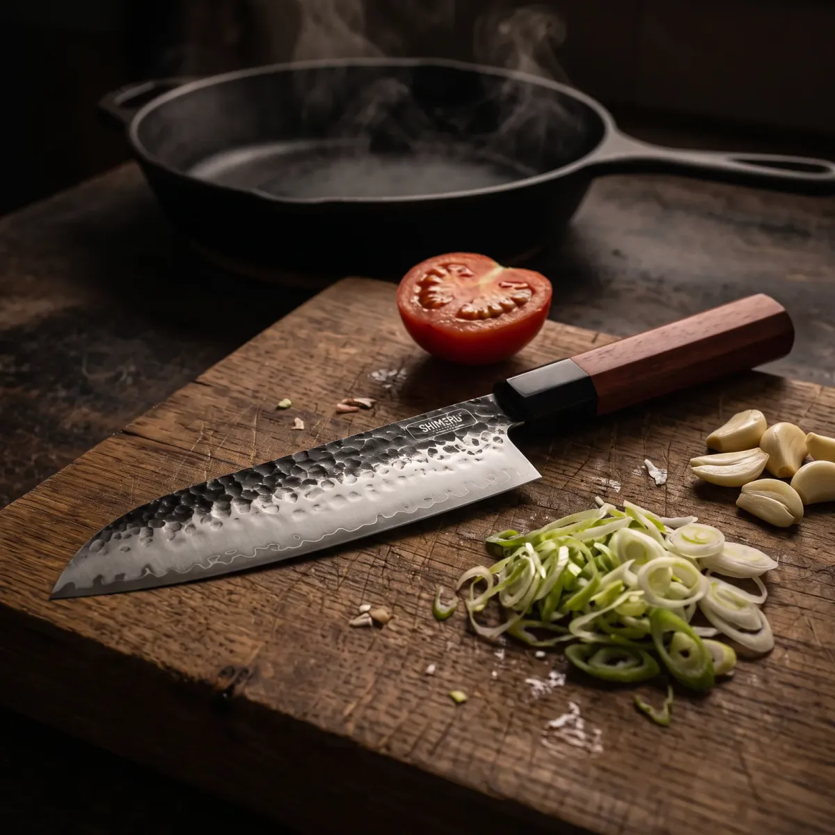 Yodo 7.5" Santoku Knife on an oak board with spring onions, tomato and garlic